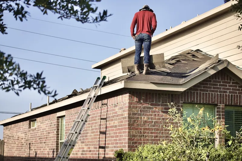Professional roofer working on a residential roof in Kingsville